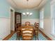 Formal dining room with light blue walls, hardwood floors and a wooden table at 401 Streamwood Dr, Holly Springs, NC 27540
