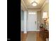 Bright entryway with hardwood floors and a wooden console table at 401 Streamwood Dr, Holly Springs, NC 27540