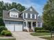 Two-story home with gray siding, white trim, and a two-car garage at 401 Streamwood Dr, Holly Springs, NC 27540