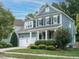 Two-story home with gray siding, white trim, and a covered porch at 401 Streamwood Dr, Holly Springs, NC 27540
