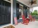 Inviting front porch with red rocking chairs and American flag at 401 Streamwood Dr, Holly Springs, NC 27540