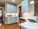 Kitchen with light blue cabinets, stainless steel appliances, and white countertops at 401 Streamwood Dr, Holly Springs, NC 27540
