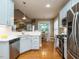 Kitchen with light blue cabinets, stainless steel appliances, and white countertops at 401 Streamwood Dr, Holly Springs, NC 27540