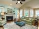 Spacious living room featuring a fireplace and a comfy green sofa at 401 Streamwood Dr, Holly Springs, NC 27540