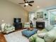 Spacious living room featuring a fireplace and a comfy green sofa at 401 Streamwood Dr, Holly Springs, NC 27540