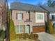 Two-story brick home with a brown garage door and landscaping at 4033 Periwinkle Blue Ln, Raleigh, NC 27612