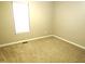 Simple carpeted bedroom with neutral walls and window at 409 James Toney Dr, Elon, NC 27244