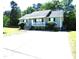 Charming single-story home featuring a well-manicured lawn, landscaped yard, and a large driveway at 409 James Toney Dr, Elon, NC 27244