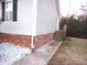Exterior home view with brick foundation, siding, and sidewalk at 409 James Toney Dr, Elon, NC 27244