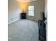Bright bedroom with carpeted floor, large window, and a media console at 4232 Vienna Crest Dr, Raleigh, NC 27613