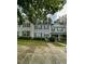 Two story townhomes with neutral and brick siding, green shutters, and a manicured lawn at 4232 Vienna Crest Dr, Raleigh, NC 27613