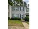 Two-story townhome with neutral siding, green shutters, and a manicured lawn at 4232 Vienna Crest Dr, Raleigh, NC 27613