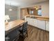 Modern kitchen featuring white cabinets, wood-look flooring, and an island with seating at 4232 Vienna Crest Dr, Raleigh, NC 27613