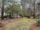 Landscaped backyard with mature trees and partial fencing at 5101 Hogans Way, Clayton, NC 27520