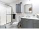 Updated bathroom features glass-enclosed shower, gray vanity with white countertop, and framed mirror at 5101 Hogans Way, Clayton, NC 27520