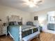Bedroom with queen bed, ceiling fan, and access to bathroom at 5101 Hogans Way, Clayton, NC 27520