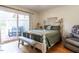 Bright bedroom with queen bed, access to deck, and wood floors at 5101 Hogans Way, Clayton, NC 27520