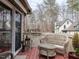 Enjoy the view of the surrounding woods from this deck with comfortable wicker furniture and privacy at 5101 Hogans Way, Clayton, NC 27520