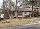 Tan two-story house with red trim, landscaped yard, and walkway at 5101 Hogans Way, Clayton, NC 27520