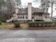 Tan two-story house with a brick base and multiple decks at 5101 Hogans Way, Clayton, NC 27520