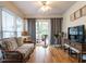 Cozy living room with hardwood floors, a sliding glass door and comfortable seating at 5101 Hogans Way, Clayton, NC 27520