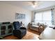 Comfortable living room featuring a sofa, a comfortable recliner, and hardwood flooring at 5101 Hogans Way, Clayton, NC 27520