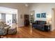 Bright living room with hardwood floors, comfortable seating, and a view to the porch at 5101 Hogans Way, Clayton, NC 27520
