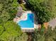 Outdoor swimming pool aerial view, shaded by mature trees, with lounge chairs at 5101 Hogans Way, Clayton, NC 27520