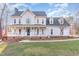 Two-story house with a wraparound porch and landscaped lawn at 6132 Wolverhampton Dr, Raleigh, NC 27603