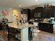 Modern kitchen with granite island and dark cabinetry at 70 Maxwell Pl, Lillington, NC 27546