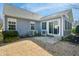 Cozy back patio features a chair, sliding glass doors, and gray siding at 701 Brickstone Dr, Apex, NC 27502