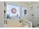Modern bathroom with a glass shower and a soaking tub next to a frosted window at 701 Brickstone Dr, Apex, NC 27502