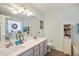 Bathroom featuring dual sinks with a large mirror and a separate enclosed tub and shower at 701 Brickstone Dr, Apex, NC 27502