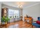 Bright dining room featuring hardwood floors, large window, and elegant decor at 701 Brickstone Dr, Apex, NC 27502
