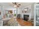 Open living room with hardwood floors, fireplace, and seamless flow to dining area at 701 Brickstone Dr, Apex, NC 27502
