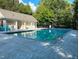 Community pool features a pool house, black fencing, and lush greenery at 701 Brickstone Dr, Apex, NC 27502