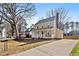 House exterior with driveway, landscaping, and mature trees at 7120 Sandringham Dr, Raleigh, NC 27613