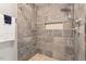 Spa-like shower with large format tile and pebble floor at 7120 Sandringham Dr, Raleigh, NC 27613