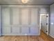 Stylish gray accent wall with paneled detailing and light hardwood floors at 727 Cook Rd, Durham, NC 27713