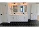 Bathroom featuring a double sink vanity with black hardware and patterned tile floors at 727 Cook Rd, Durham, NC 27713
