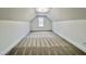 A carpeted bedroom features an attic ceiling and a window with views of the neighborhood at 727 Cook Rd, Durham, NC 27713