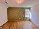 A bright bedroom is enhanced by hardwood floors, a decorative wall, and a modern light fixture at 727 Cook Rd, Durham, NC 27713