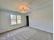 Sun-filled bedroom with a decorative chandelier and a large window at 727 Cook Rd, Durham, NC 27713