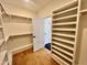 Walk-in closet featuring custom shelving for organization and hardwood flooring at 727 Cook Rd, Durham, NC 27713