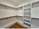 Walk-in closet with custom shelving and hardwood floors at 727 Cook Rd, Durham, NC 27713