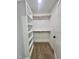 A walk-in closet features carpet floors, shelving and clothes rods for ample storage space at 727 Cook Rd, Durham, NC 27713