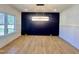 Dining room with black accent wall, hardwood floors, and a stunning modern chandelier at 727 Cook Rd, Durham, NC 27713