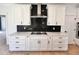 Kitchen featuring white cabinetry, stainless steel appliances, tile backsplash, and modern hardware at 727 Cook Rd, Durham, NC 27713