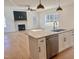 Open kitchen featuring white cabinetry, stainless steel appliances, granite countertops, and a view of the living room at 727 Cook Rd, Durham, NC 27713