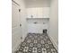 Laundry room featuring patterned tile floors, white cabinets, and laundry hookups at 727 Cook Rd, Durham, NC 27713